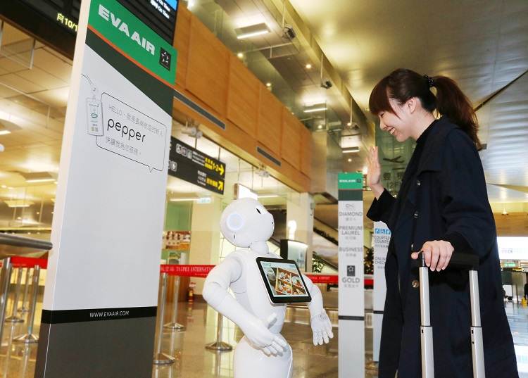Robot Pepper da Companhia aérea Eva Air a dar assistência a um passageiro